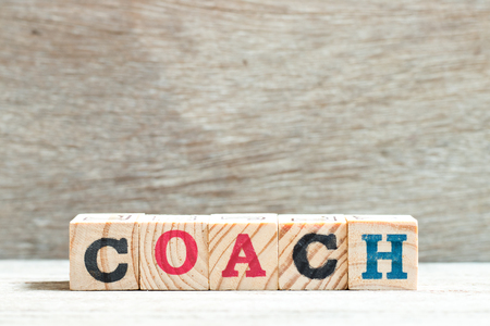 Alphabet letter block in word coach on wood backgroundの写真素材