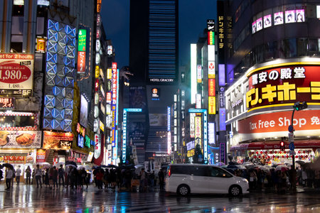 Tokyo, Japan - May 1, 2019 : Crowd wait to cross the road at street in front of Kabukicho district in Tokyo Japan. Kabukicho is the street that have godzilla head at hotel gracery, entertainment and bar.のeditorial素材