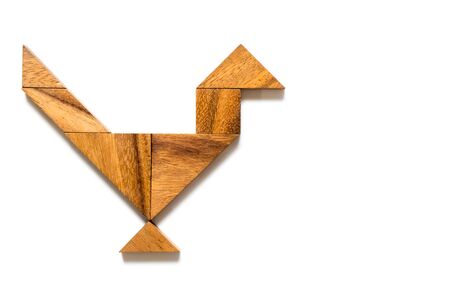 Wooden tangram puzzle in bird shape on white backgroundの写真素材