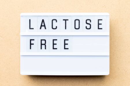 White lightbox with word lactose free on wood backgroundの写真素材