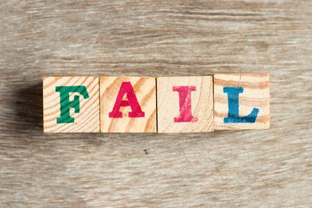 Letter block in word fail on wood backgroundの写真素材