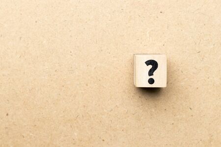Alphabet letter block in question mark sign on wood backgroundの写真素材