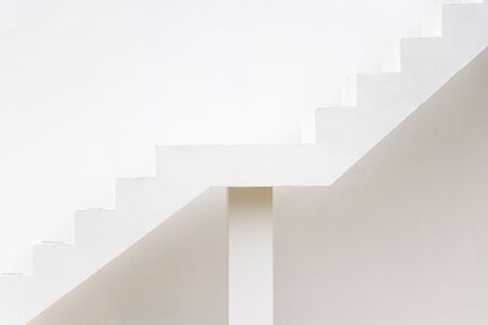 White staircase on concrete wall background (Concept for career path, target aiming, aspiration)の写真素材