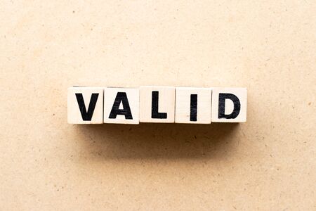 Letter block in word valid on wood background