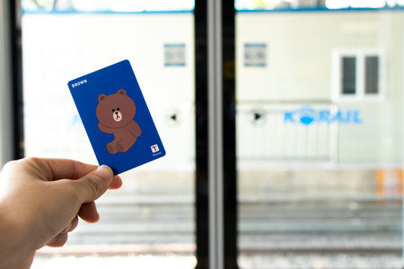 Seoul, South Korea- Oct 21, 2019  : Traveller hand hold t money card with line cartoon character on...
