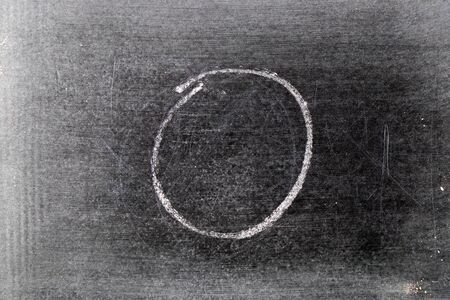 White chalk hand drawing in circle or round shape on black board backgroundの写真素材