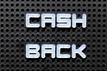 White color alphabet with word cash back on black pegboard background