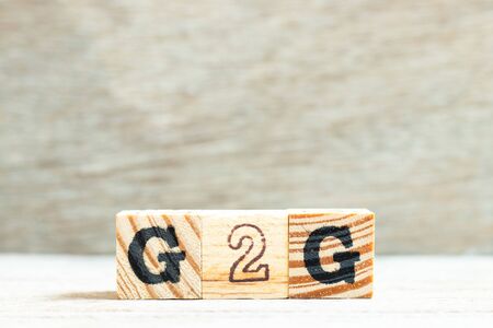 Alphabet letter in word G2G (abbreviation of Government to government) on wood backgroundの写真素材