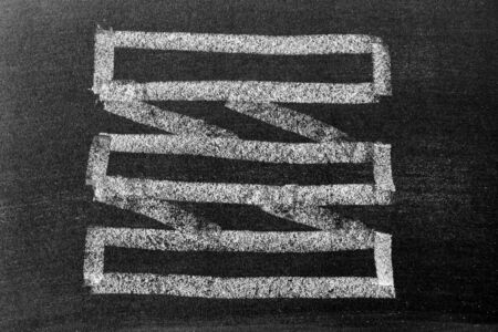 White chalk hand drawing in blank award ribbon banner shape on blackboard backgroundの写真素材