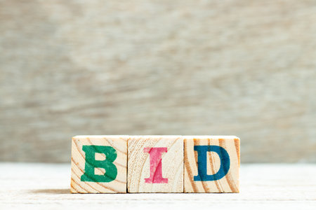 Alphabet letter in word bid on wood backgroundの写真素材