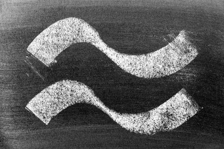 White color chalk hand drawing in set of curve or wavy line shape on black board backgroundの写真素材