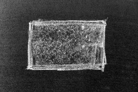 White color chalk hand drawing in line or square shape on black board backgroundの写真素材