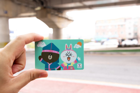 Seoul, South Korea- Oct 23, 2019 : Traveller hand hold t money card with line cartoon character on...