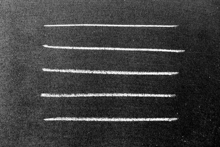 White color chalk hand drawing in set of line or square shape on black board backgroundの写真素材