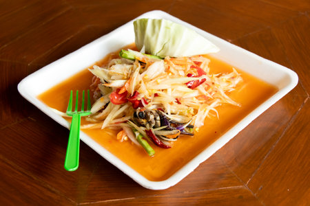 Papaya salad, Thai food name Som Tum, on white foam plate backgroundの写真素材