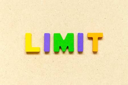 Color alphabet letter with word limit on wood backgroundの写真素材
