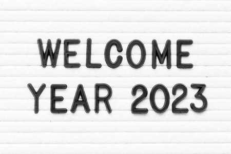 Black color letter in word welcome year 2023 on white felt board backgroundの写真素材
