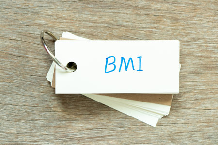 Flash card with handwriting word BMI (abbreviation of body mass index) on wood backgroundの写真素材