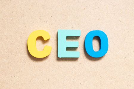 Color alphabet letter in word CEO (Abbreviation of Chief Executive Officer) on wood backgroundの写真素材