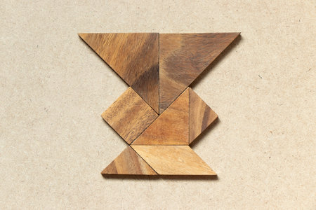 Wooden tangram in  vase or jar shape on wood backgroundの写真素材