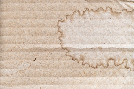 Water stained on brown corrugated packaging material backgroundの写真素材