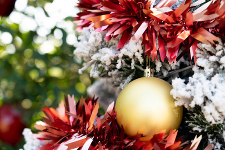 Background of gold decoration ball on christmas tree with another ornamentの写真素材