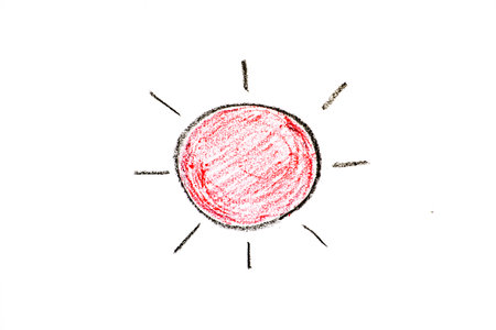 Color oil pastel hand drawing in sun with ray shape on white paper backgroundの写真素材