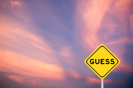 Yellow transportation sign with word guess on violet color sky backgroundの写真素材