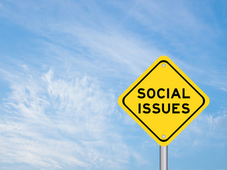 Yellow transportation sign with word social issues on violet color sky backgroundの写真素材