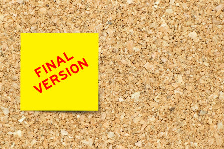 Yellow note paper with word final version on cork board background with copy space