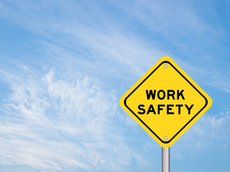 Yellow transportation sign with word work safety on blue color sky backgroundの写真素材
