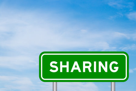 Green color transportation sign with word sharing on blue sky with white cloud backgroundの写真素材