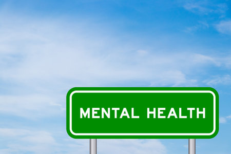 Green color sign with word mental health on blue sky with white cloud backgroundの写真素材
