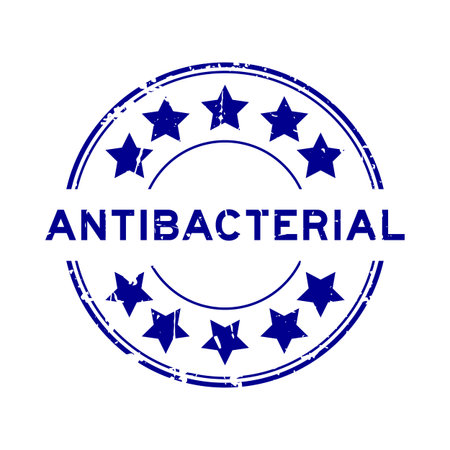 Grunge blue antibacterial word with star icon round rubber seal stamp on white backgroundのイラスト素材