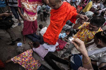 KANCHANABURI ,THAILAND - APRIL 17:The unidentified people pour the water into the bamboo rails to water a monk in Songkran festival on April 17, 2014 in Sangkhla Buri, Kanchanaburi , Thailand.のeditorial素材