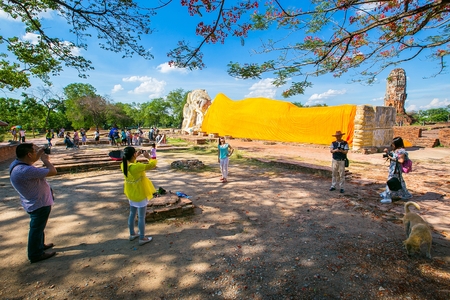 AYUTTHAYA THAILAND  MAY 17: Tourists visit the Reclining Buddha of Wat Lokaya Sutha in Ayutthaya Thailand on May 17 2015. Wat Lokaya Sutha is located directly west of the Royal Palaceのeditorial素材