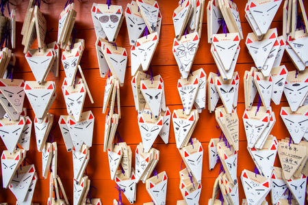 KYOTO, JAPAN - MARCH 24, 2016 : Ema prayer tables with unique fox-shaped boards at Fushimi Inari Taisha Temple in Kyoto. Pray for luck, wealth, happiness, health, fortune, protection.のeditorial素材