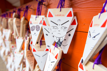 KYOTO, JAPAN - MARCH 24, 2016 : Ema prayer tables with unique fox-shaped boards at Fushimi Inari Taisha Temple in Kyoto. Pray for luck, wealth, happiness, health, fortune, protection.のeditorial素材