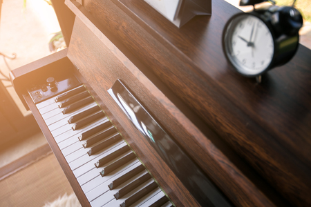 alarm clock on pianoの写真素材