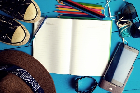 Tourism planning and equipment needed for the trip on wooden floorの写真素材