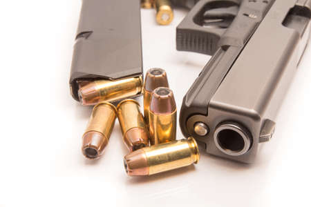 close-up on .45acp ammo with a handgun.の写真素材