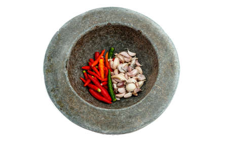 chilly and garic in mortaron white backgroundの写真素材