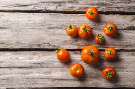 Fresh organic tomatoes on a rustic wooden table. Top view, flat lay.の写真素材