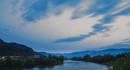 Moving clouds above the flowing Drina river