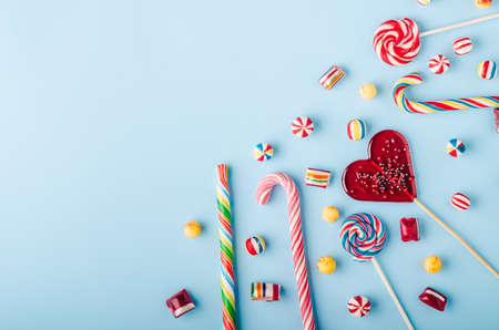 Candies and lollipops on blue backgroundの写真素材