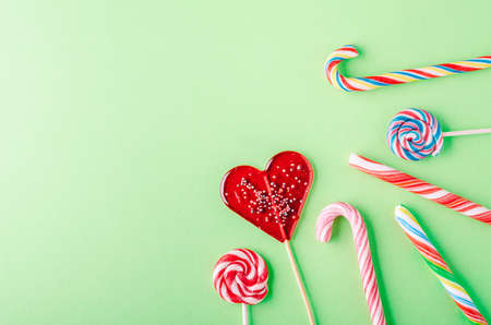 Candies and lollipops on a green background