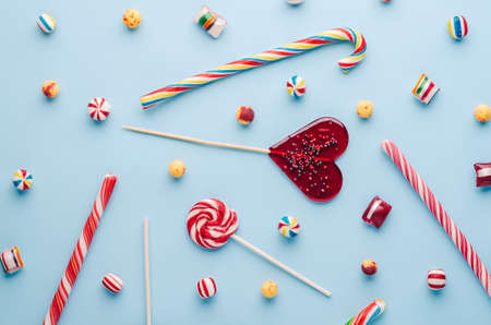 Candies and lollipops on blue backgroundの写真素材