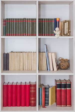 Wooden shelf full of books. Home library.の写真素材