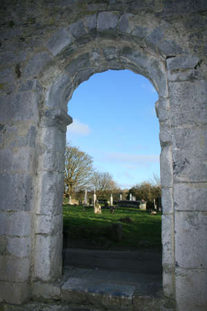 Cemetery view through door of historic ruined church in Irelandの写真素材