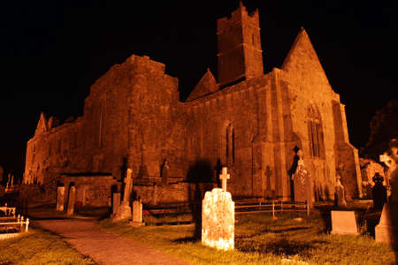 Ruins of Quin abbey and cemetery at night dating to the 13th century. It is located in county Clare, Irelandの写真素材
